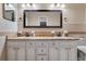 Bathroom featuring double sinks, large mirror, spacious countertop and traditional cabinetry with detailed hardware at 146 Tollgate Trl, Longwood, FL 32750