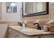 Bathroom with a double vanity, granite counters, and unique white and brown tiled walls at 146 Tollgate Trl, Longwood, FL 32750