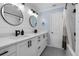 Bright bathroom features a dual sink vanity with modern fixtures and stylish round mirrors at 146 Tollgate Trl, Longwood, FL 32750