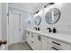 Bright bathroom features a dual sink vanity with modern fixtures and stylish round mirrors at 146 Tollgate Trl, Longwood, FL 32750