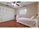 Cozy bedroom features a ceiling fan, window, closet, and hardwood floors at 146 Tollgate Trl, Longwood, FL 32750