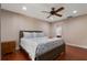 Comfortable bedroom with cherry floors, recessed lights, ceiling fan, and queen-sized bed with patterned linens at 146 Tollgate Trl, Longwood, FL 32750