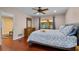 Primary bedroom with wood floors, ceiling fan, and natural light at 146 Tollgate Trl, Longwood, FL 32750