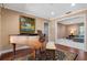 Open dining room featuring wood floors, a piano, and access to the living room at 146 Tollgate Trl, Longwood, FL 32750