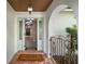 Inviting home entryway with brick flooring, decorative sidelights, and arched entry to the main living space at 146 Tollgate Trl, Longwood, FL 32750