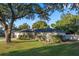 A picturesque home featuring a well-kept lawn, complemented by a mature, grand tree at 146 Tollgate Trl, Longwood, FL 32750