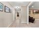 Hallway featuring tile flooring, neutral paint, updated lighting, and views into the living and dining spaces at 146 Tollgate Trl, Longwood, FL 32750