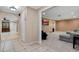 Hallway with ceramic tile flooring leads to a living room with neutral carpeting at 146 Tollgate Trl, Longwood, FL 32750