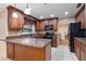 Kitchen boasts wooden cabinets, granite countertops, and stainless steel appliances for modern living at 146 Tollgate Trl, Longwood, FL 32750