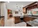 Eat-in kitchen showcasing stainless appliances, granite countertops, and beautiful wood cabinetry at 146 Tollgate Trl, Longwood, FL 32750