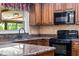 Modern kitchen with granite countertops, stainless steel appliances, and natural lighting at 146 Tollgate Trl, Longwood, FL 32750