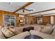 Cozy living room featuring wood paneling, beams, and sliding glass doors at 146 Tollgate Trl, Longwood, FL 32750