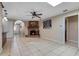 Spacious living room with brick fireplace, tile floors, ceiling fan, and lots of natural light at 146 Tollgate Trl, Longwood, FL 32750