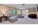 Spacious living room with a comfortable gray sectional, neutral carpet, updated lighting, and bright windows at 146 Tollgate Trl, Longwood, FL 32750