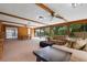 Bright living area featuring wooden beams, ceiling fans, and large windows with furniture at 146 Tollgate Trl, Longwood, FL 32750