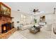 Inviting living room featuring a brick fireplace and comfortable seating, perfect for relaxation at 146 Tollgate Trl, Longwood, FL 32750