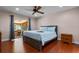 Main bedroom with hardwood floors, ceiling fan, and sliding glass doors to the sunroom at 146 Tollgate Trl, Longwood, FL 32750