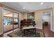 Room with hardwood flooring, piano, and sliding glass doors to a sunroom at 146 Tollgate Trl, Longwood, FL 32750