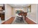 Room with hardwood flooring, piano, and sliding glass doors to a sunroom at 146 Tollgate Trl, Longwood, FL 32750