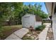 A backyard shed with walkway adds utility and character to the outdoor space at 146 Tollgate Trl, Longwood, FL 32750