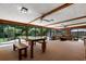 Spacious sunroom with a wood table and bench, plus outdoor views through many windows at 146 Tollgate Trl, Longwood, FL 32750