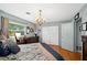 Well-lit bedroom with hardwood floors, decorative chandelier, and a closet with white doors at 1516 Arthur St, Orlando, FL 32804