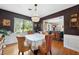Elegant dining room featuring a chandelier, dark walls, hardwood floors, and natural light at 1516 Arthur St, Orlando, FL 32804