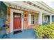 Inviting brick front porch featuring a vibrant red door, a 'Welcome' mat, and stylish exterior details at 1516 Arthur St, Orlando, FL 32804