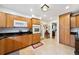 Spacious kitchen showcasing wood cabinets, granite countertops, and tile flooring at 1516 Arthur St, Orlando, FL 32804