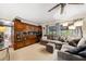 Comfortable living room featuring a large cabinet, neutral carpet, and big sectional couch at 1516 Arthur St, Orlando, FL 32804