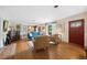 Bright living room featuring hardwood floors, stylish furnishings, and direct access to dining area at 1516 Arthur St, Orlando, FL 32804