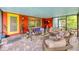 Vibrant outdoor patio with colorful furniture, swing, and lots of seating for entertaining at 1516 Arthur St, Orlando, FL 32804