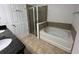 Bathroom featuring a soaking tub, glass-enclosed shower, and granite vanity at 15637 Carina Dr, Orlando, FL 32828