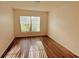 Bright bedroom with wood floors and a window offering natural light, creating a serene atmosphere at 15637 Carina Dr, Orlando, FL 32828