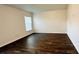 Spacious bedroom with wood floors and a window, perfect for creating a cozy and inviting retreat at 15637 Carina Dr, Orlando, FL 32828