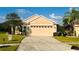 Inviting single-story home with a spacious driveway and a manicured lawn, offering curb appeal at 15637 Carina Dr, Orlando, FL 32828