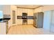 Modern kitchen with stainless steel appliances, tile backsplash, and a pantry, designed for convenience at 15637 Carina Dr, Orlando, FL 32828