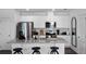 Modern kitchen featuring white cabinets, stainless steel appliances, granite countertops, and a stylish island with bar stool seating at 16341 Lakelet Aly, Winter Garden, FL 34787