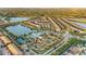 Overhead view of community amenities including pool, clubhouse, tennis, and lakeside homes at 2186 Tripoli Ct, Kissimmee, FL 34747