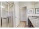 Bright bathroom featuring a glass shower, granite vanity, and access to another room at 2186 Tripoli Ct, Kissimmee, FL 34747
