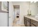 Bathroom with granite counters, dark cabinets, and a doorway to the bedroom at 2186 Tripoli Ct, Kissimmee, FL 34747
