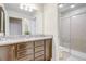 Bathroom featuring double sink vanity with granite top and a glass enclosed shower at 2186 Tripoli Ct, Kissimmee, FL 34747