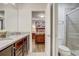 Bathroom with a granite countertop, wood cabinets, and glass-enclosed shower at 2186 Tripoli Ct, Kissimmee, FL 34747