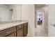 Bathroom with granite counters, dark cabinets, and a view into the adjacent bedroom at 2186 Tripoli Ct, Kissimmee, FL 34747