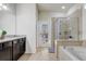 Bathroom features tile flooring, a large vanity, a glass shower, and a soaking tub under a window at 2186 Tripoli Ct, Kissimmee, FL 34747