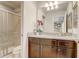 Bathroom with a granite countertop, wood cabinets, and glass-enclosed shower at 2186 Tripoli Ct, Kissimmee, FL 34747