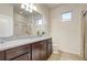 Well-lit bathroom featuring granite counters, dark cabinetry, a framed mirror, and a glass-enclosed shower at 2186 Tripoli Ct, Kissimmee, FL 34747