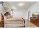 A bedroom with dark wooden furniture and neutral tones with a double-door closet and TV console at 2186 Tripoli Ct, Kissimmee, FL 34747