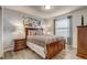 Comfortable bedroom with light gray walls, modern wooden bed, art and wood-look flooring at 2186 Tripoli Ct, Kissimmee, FL 34747