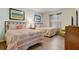 Bright bedroom featuring two beds with patterned spreads, stylish wall art, and light-colored walls at 2186 Tripoli Ct, Kissimmee, FL 34747